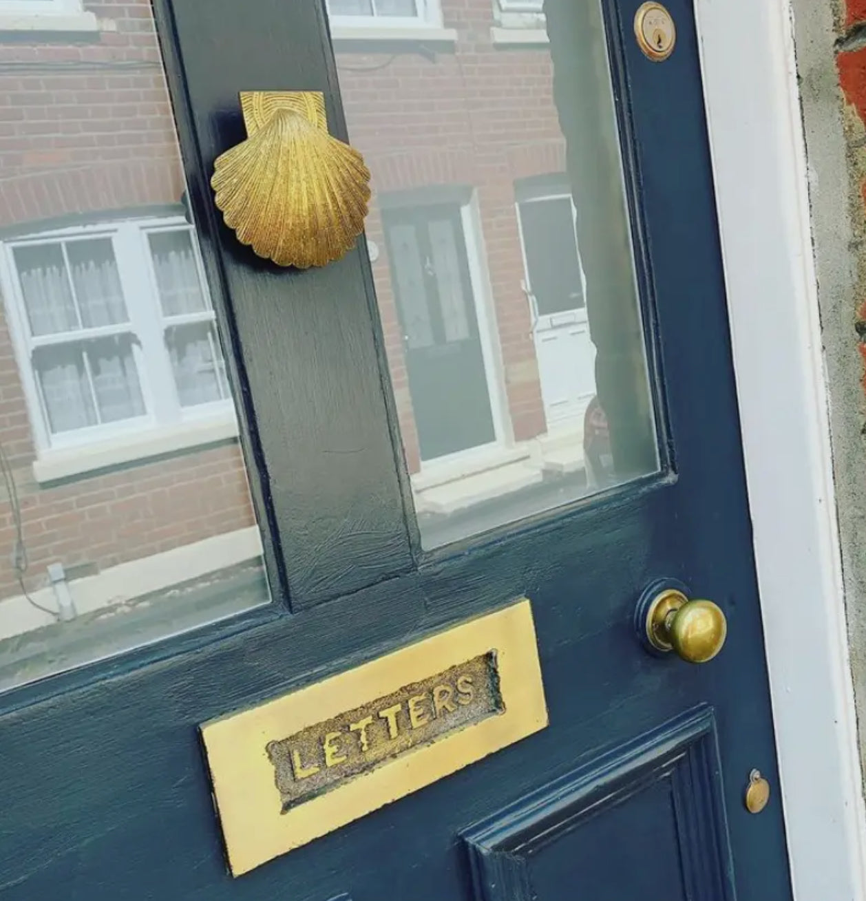 Brass shell door knocker