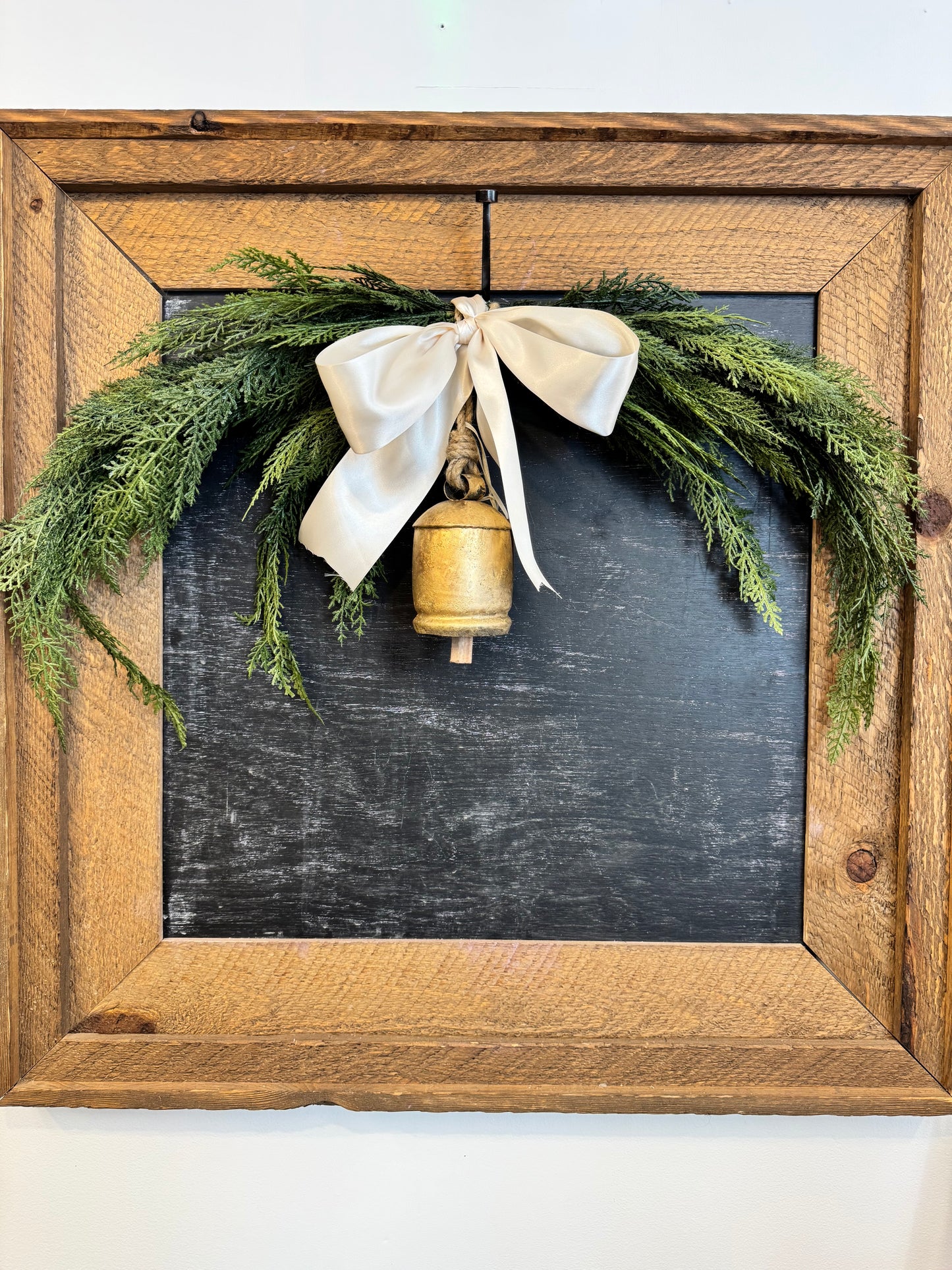 Cedar Swag with brass Bell and Ivory Satin Ribbon