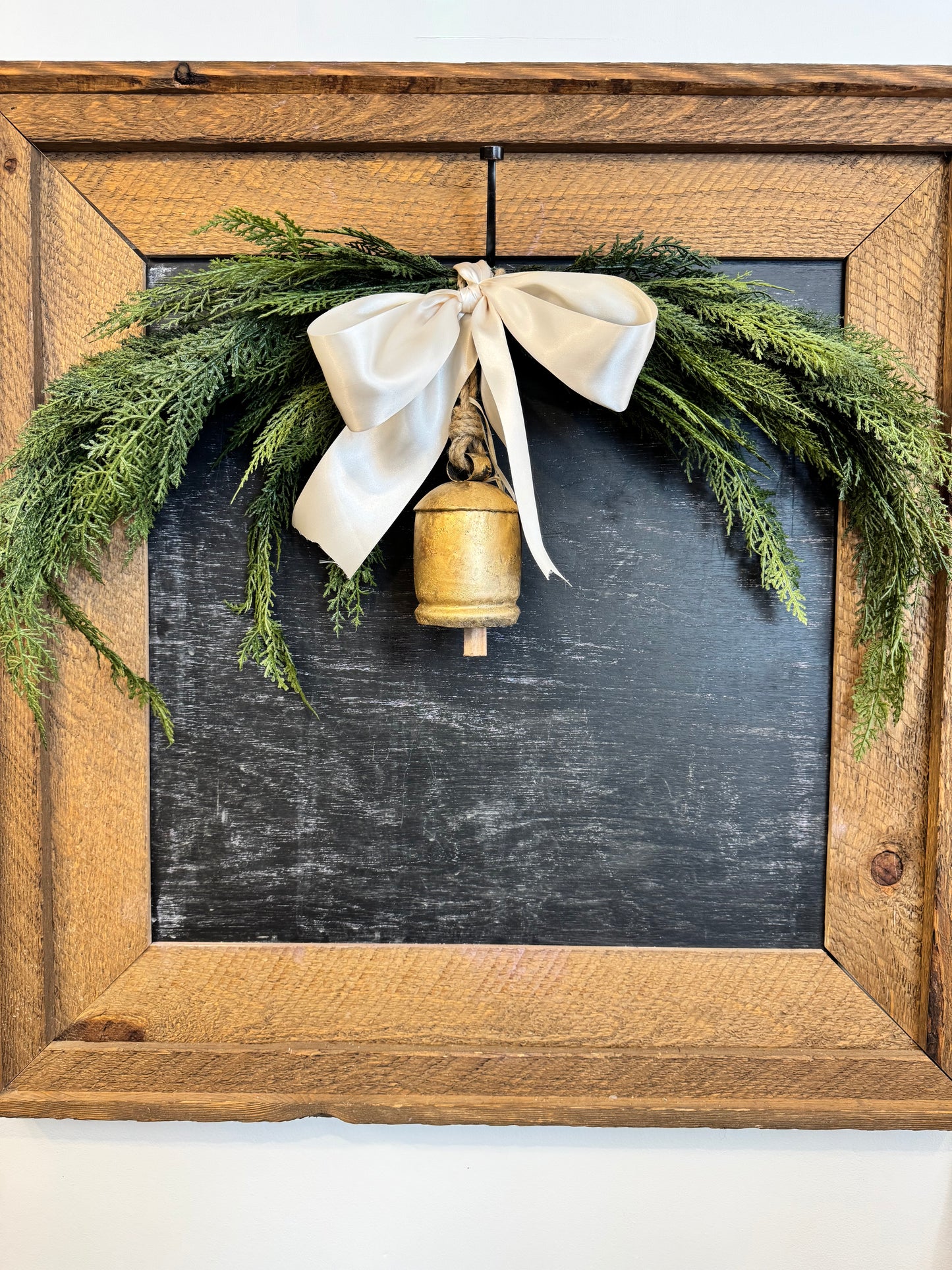 Cedar Swag with brass Bell and Ivory Satin Ribbon