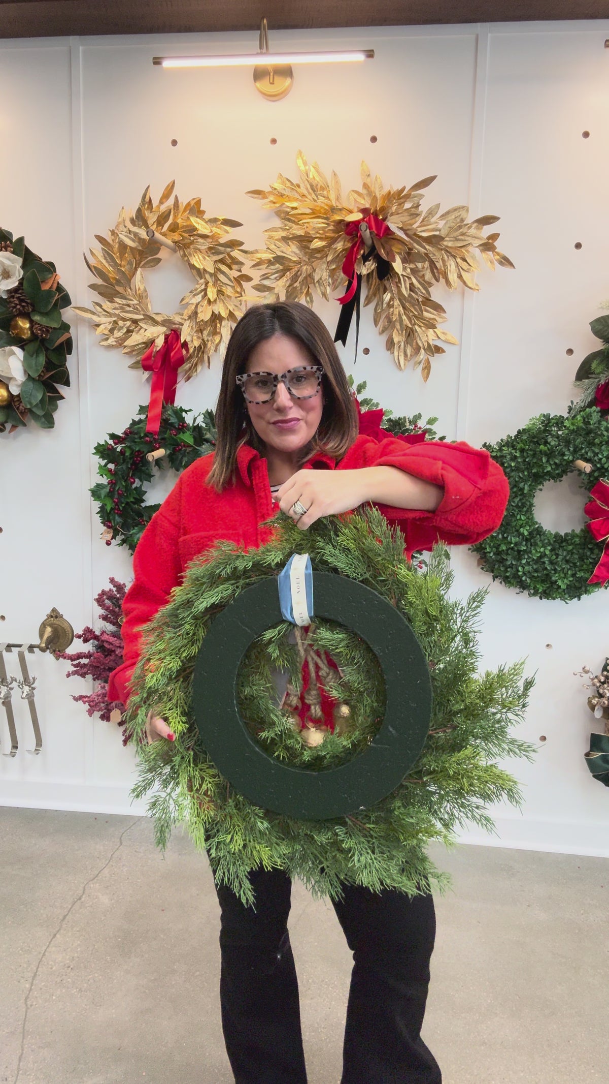 “Noel” Cedar wreath with brass bells and layered bow